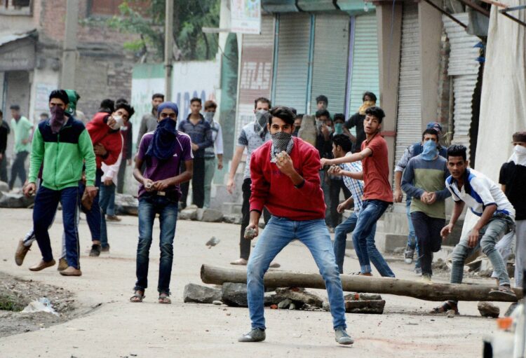 Srinagar: Protesters throwing stones on police during a clash in Srinagar on Tuesday. PTI Photo by S Irfan(PTI8_30_2016_000099B)